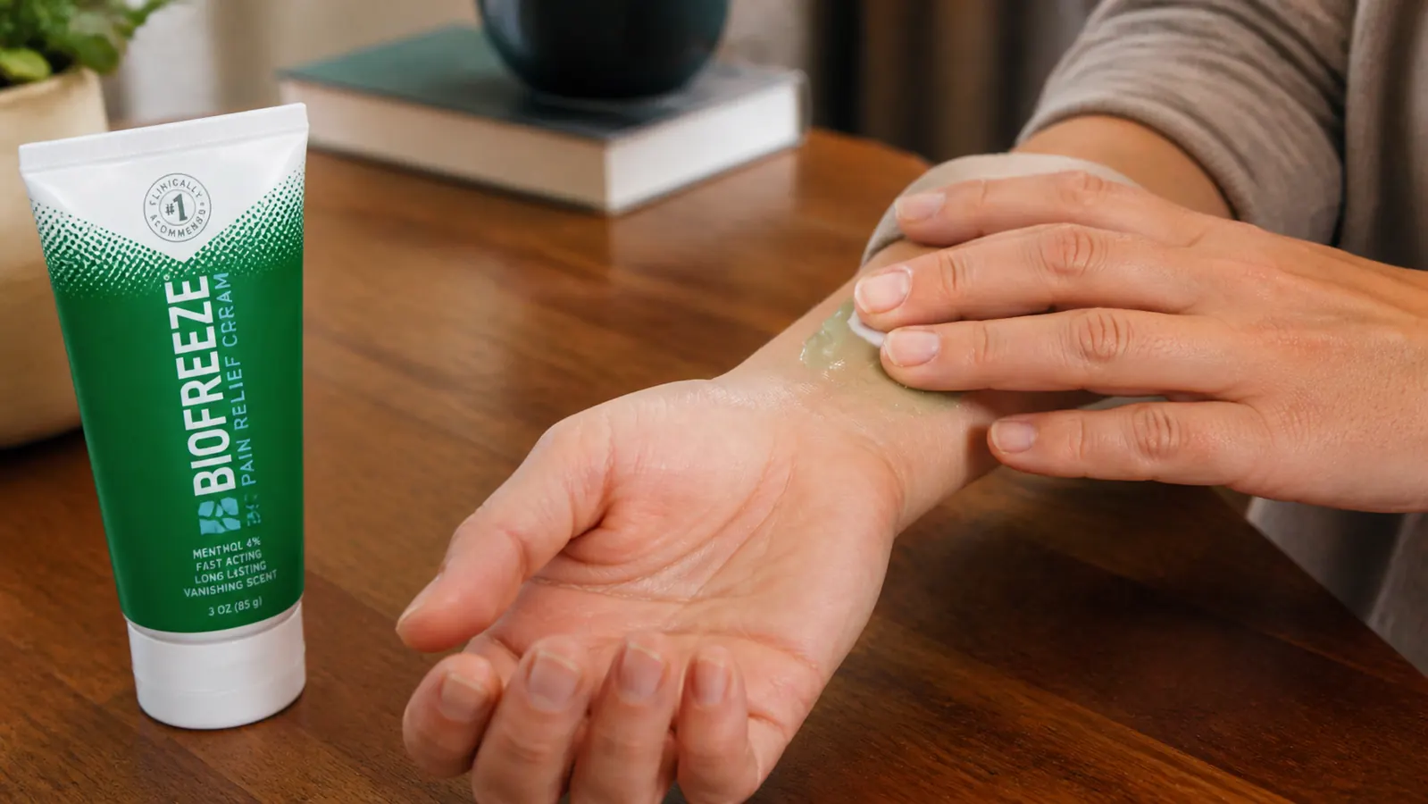 Person applying Biofreeze pain relief cream to a swollen wrist joint
